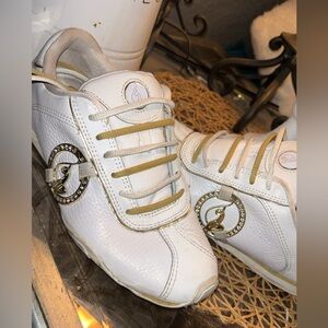 Vintage Y2K Baby Phat sneakers in white with gold accents.